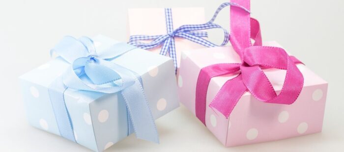 Traditional Christening Gifts Selection. Bright-coloured wrapping paper.